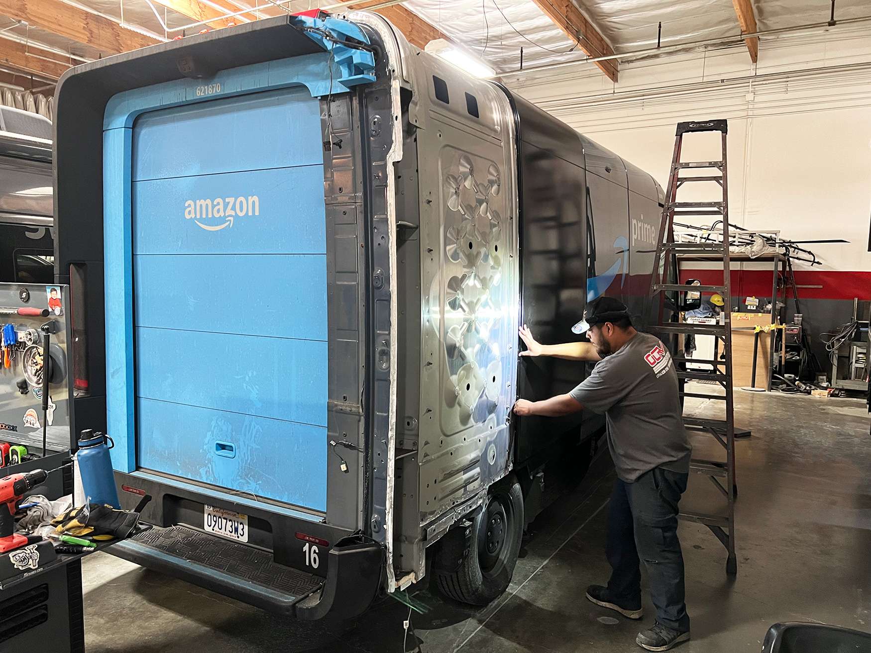 Technician working under shop lighting in a service bay