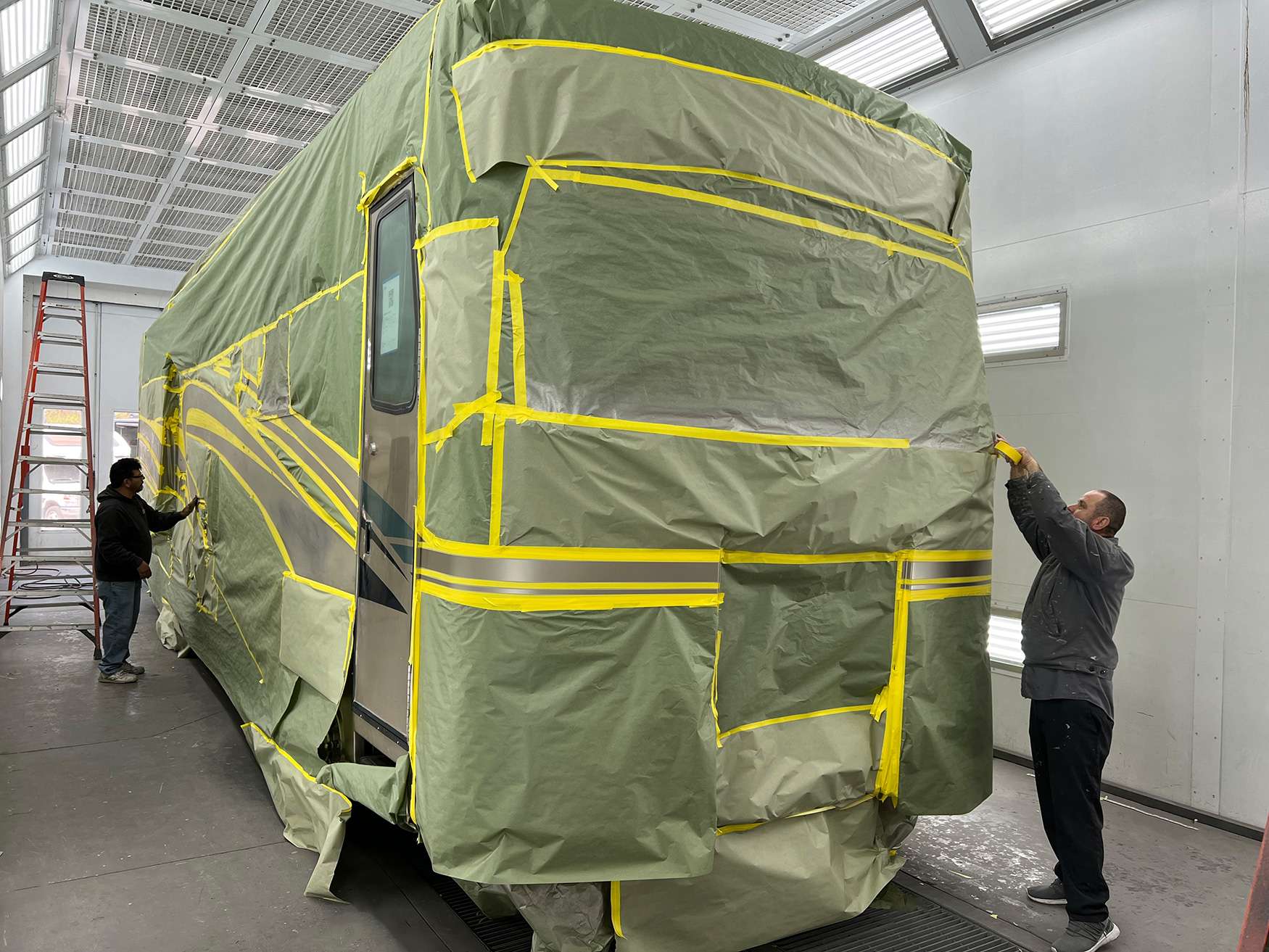 Applicator laying ceramic coating across a polished panel