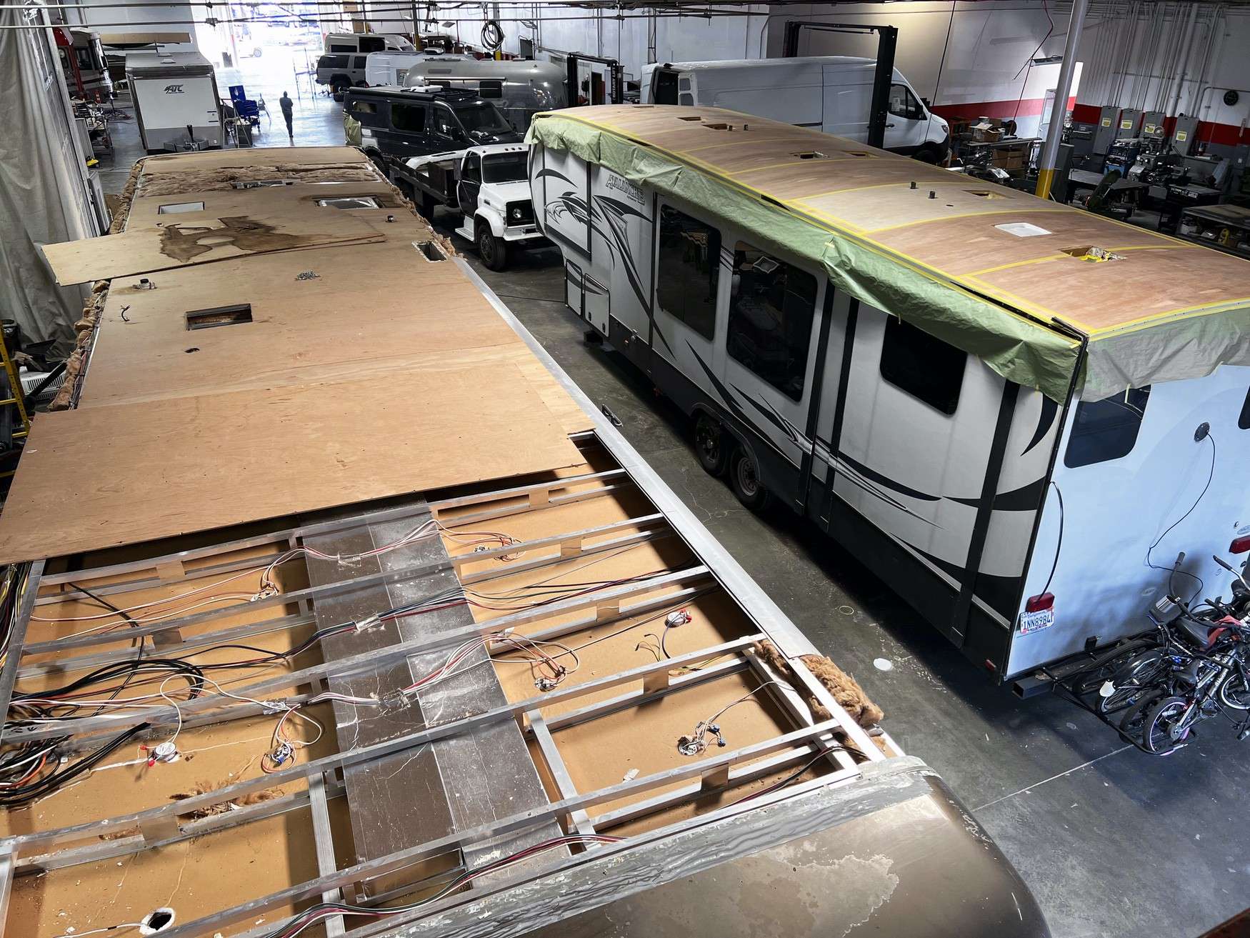 Technician resealing a membrane roof on a fifth wheel