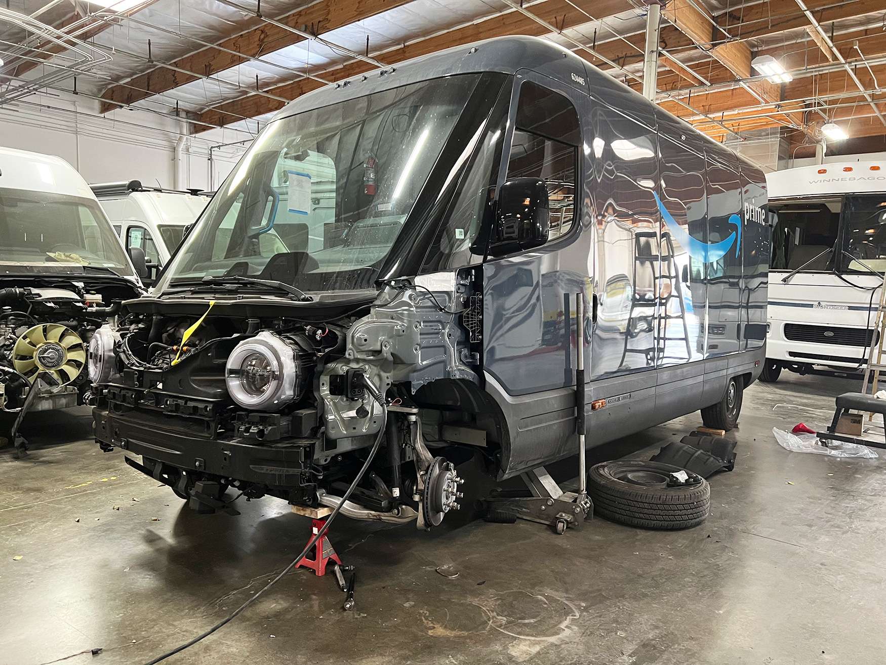Electric delivery van in a high voltage safe service bay