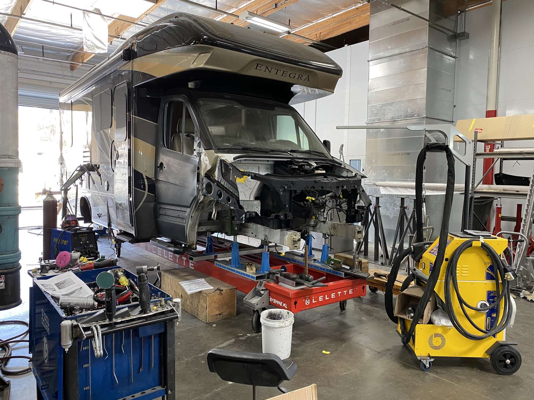 Class C motorhome with cab over section under repair